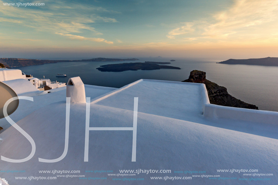 White roof and Amazing sunset in town of Imerovigli, Santorini island, Thira, Cyclades, Greece