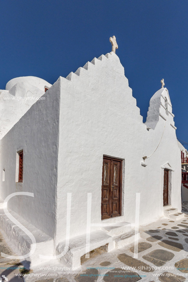 White orthodox church and small bell tower in Mykonos, Cyclades Islands, Greece