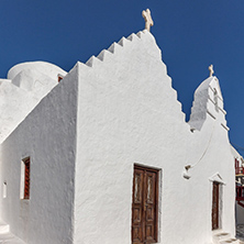 White orthodox church and small bell tower in Mykonos, Cyclades Islands, Greece