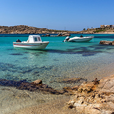 Small boat in Paranga Beach on the island of Mykonos, Cyclades, Greece