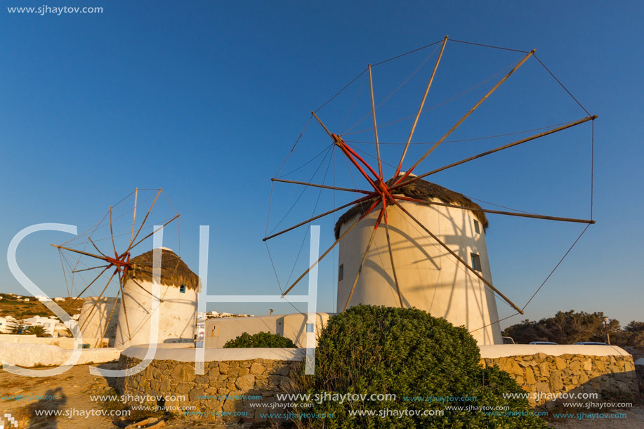 Sunset of White windmills and Aegean sea on the island of Mykonos, Cyclades, Greece