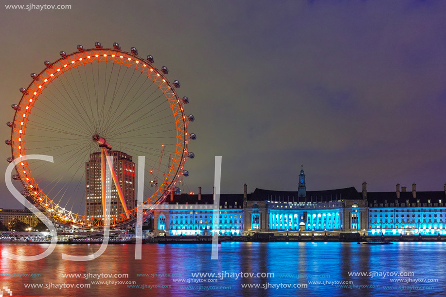 The London Eye on the South Bank of the River Thames at night in London, England, Great Britain