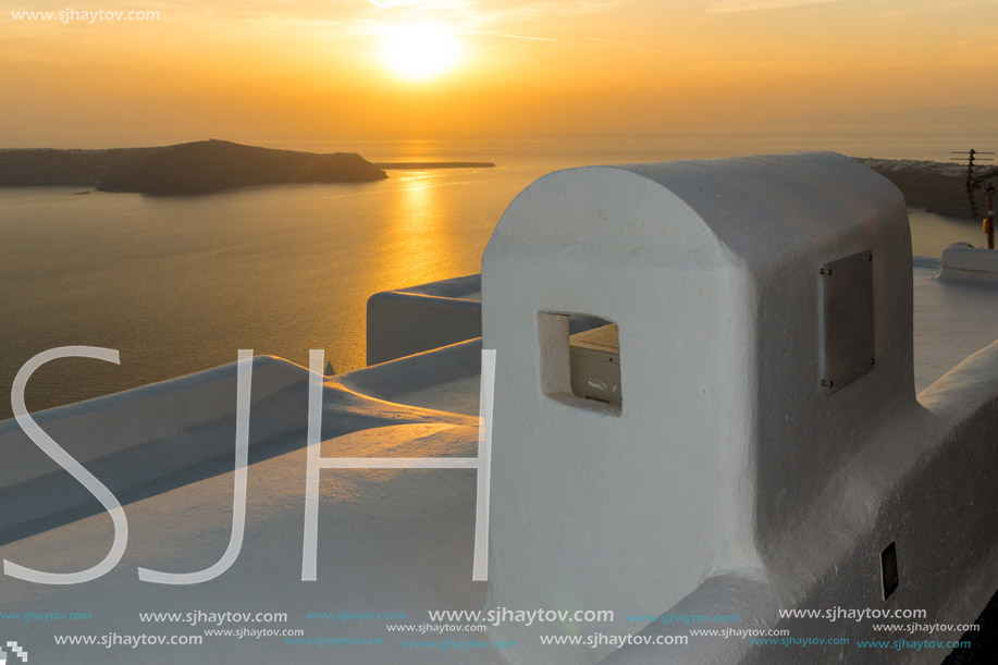 White roof and Amazing sunset in town of Imerovigli, Santorini island, Thira, Cyclades, Greece