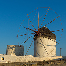 Amazing Sunset and White windmills on the island of Mykonos, Cyclades, Greece