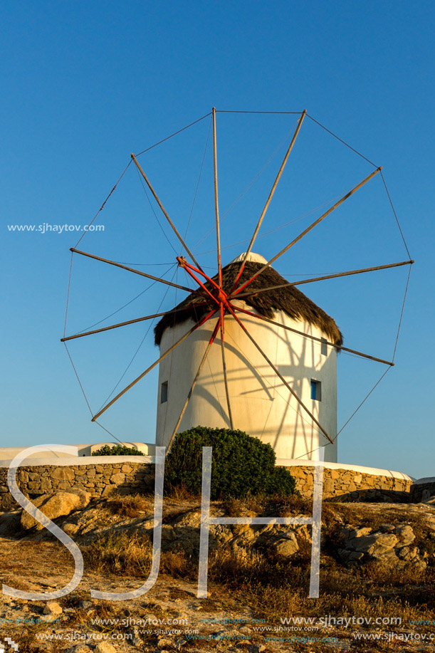 Sunset of White windmills and Aegean sea on the island of Mykonos, Cyclades, Greece