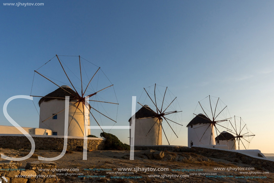 Sunset view of White windmills on the island of Mykonos, Cyclades, Greece