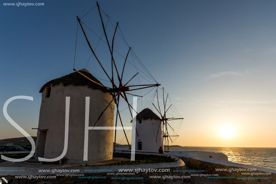 Sunset of White windmills and Aegean sea on the island of Mykonos, Cyclades, Greece