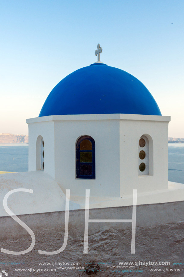 Church with blue roof in town of Oia and panorama to Santorini island, Thira, Cyclades, Greece