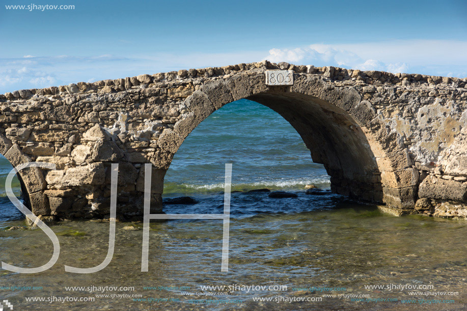 Seascape with medieval bridge in the water at Argassi beach, Zakynthos island, Greece
