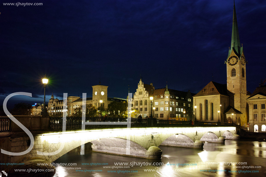 Night photo of Fraumunster Church and bridge over Limmat River, city of Zurich, Switzerland