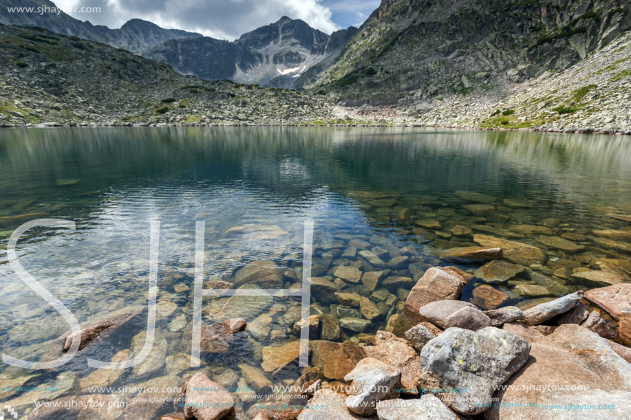 Stones in the water and reflection of Musalenski lakes,  Rila mountain, Bulgaria