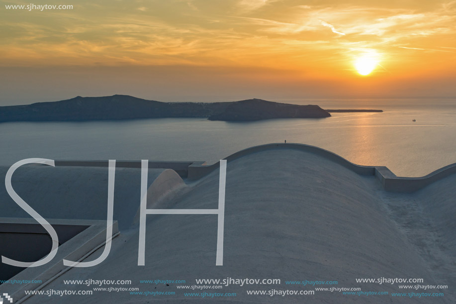 White roof and Amazing sunset in town of Imerovigli, Santorini island, Thira, Cyclades, Greece