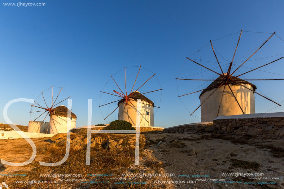 Sunset of White windmills and Aegean sea on the island of Mykonos, Cyclades, Greece