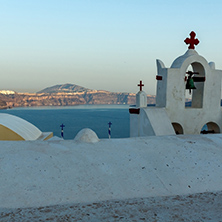 Church with blue roof in town of Oia and panorama to Santorini island, Thira, Cyclades, Greece