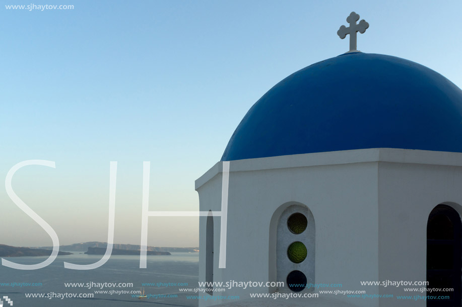 Twinlight view of Church with blue roof in town of Oia and panorama to Santorini island, Thira, Cyclades, Greece