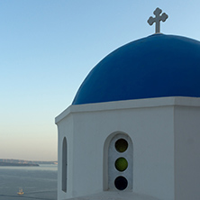 Twinlight view of Church with blue roof in town of Oia and panorama to Santorini island, Thira, Cyclades, Greece