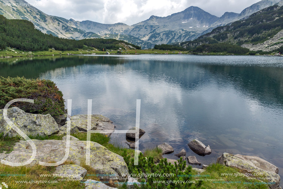 Clouds over Banderishki chukar peak and Reflection in Muratovo lake, Pirin Mountain, Bulgaria