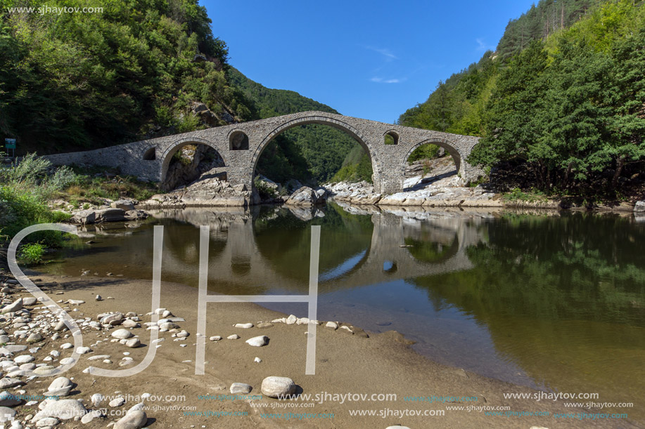 Reflection of Devil"s Bridge and Rhodopes mountain in Arda river, Kardzhali Region, Bulgaria