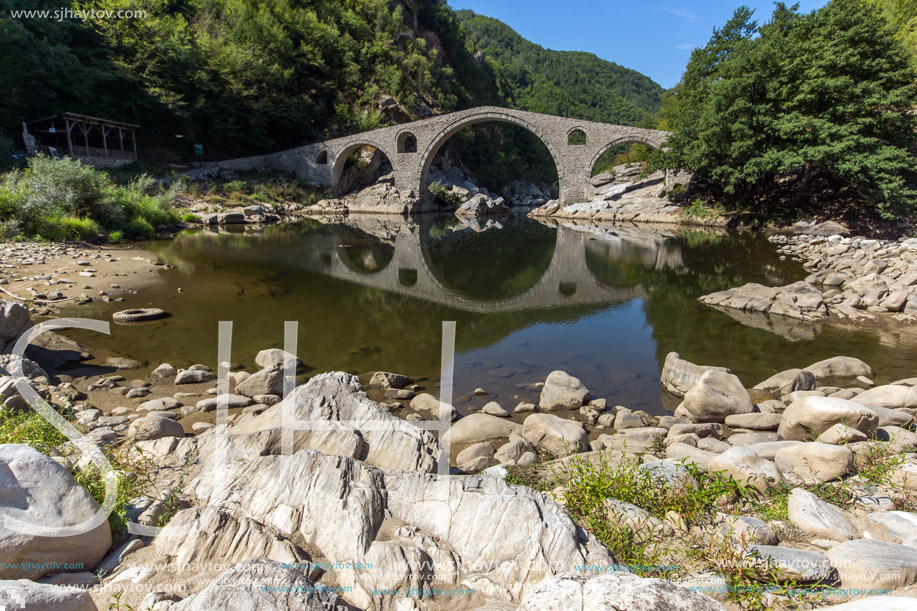 Reflection of Devil"s Bridge and Rhodopes mountain in Arda river, Kardzhali Region, Bulgaria