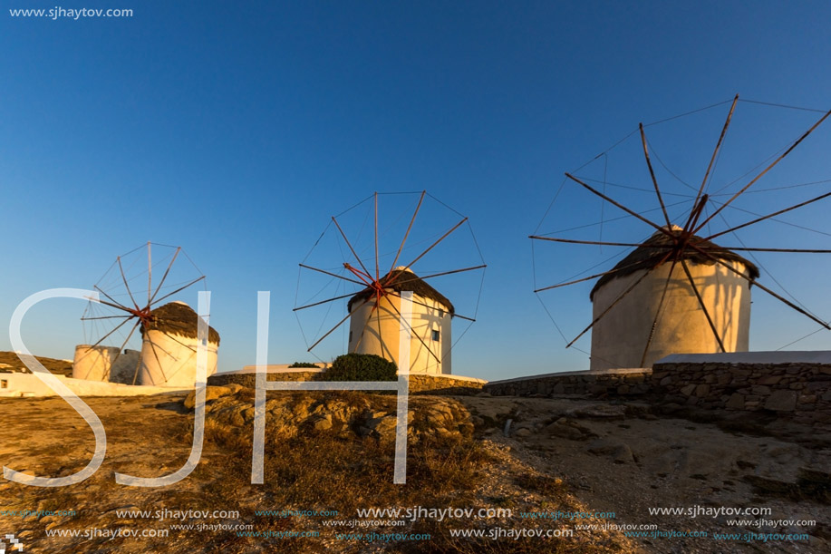 Sunset of White windmills and Aegean sea on the island of Mykonos, Cyclades, Greece