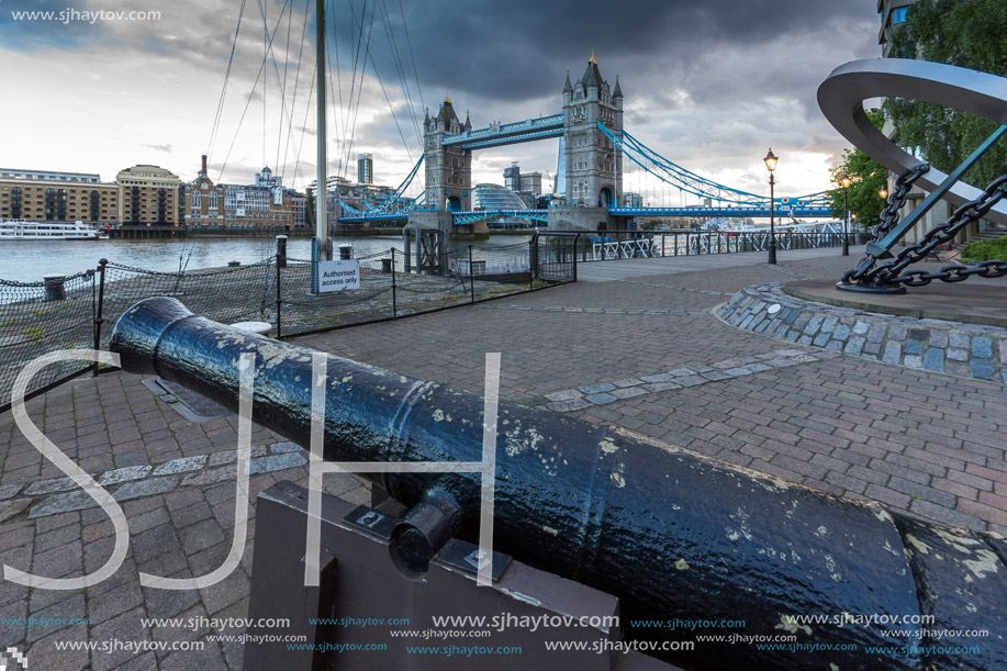 Medieval cannon and Sunset view of Tower Bridge in London, England, United Kingdom