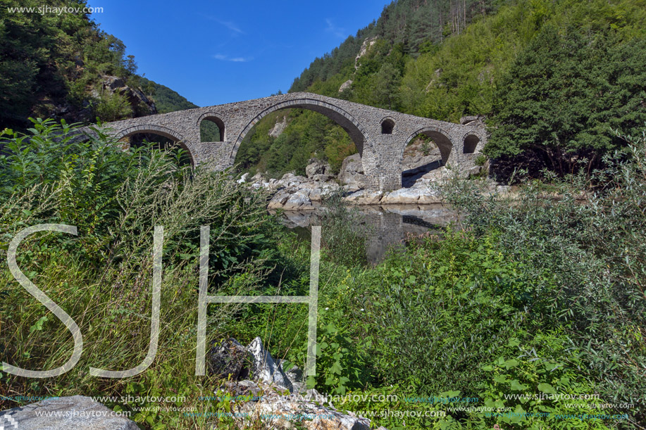 Reflection of Devil"s Bridge and Rhodopes mountain in Arda river, Kardzhali Region, Bulgaria