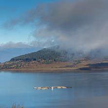 Amazing Autumn panorama with Low clouds over water of Batak Reservoir, Pazardzhik Region, Bulgaria