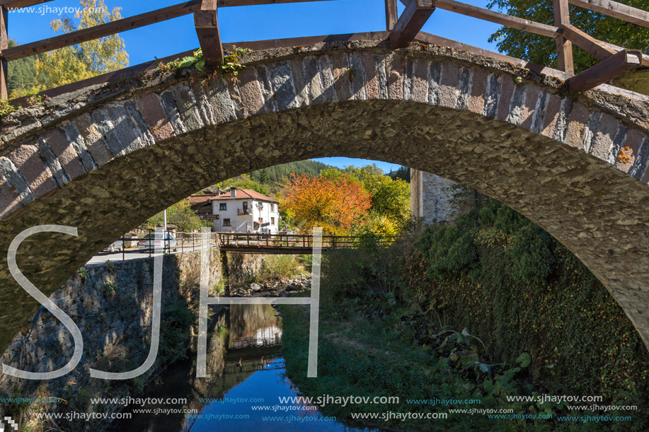 Autumn Landscape with Roman Bridge and Church of the Assumption in town of Shiroka Laka, Smolyan Region, Bulgaria