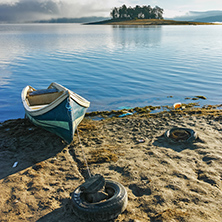 Island with pines and boat in Batak Reservoir, Pazardzhik Region, Bulgaria