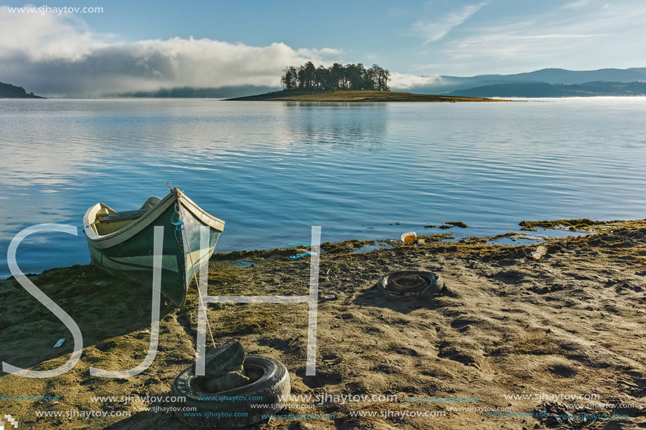 Landscape with Island with pines and boat in Batak Reservoir, Pazardzhik Region, Bulgaria