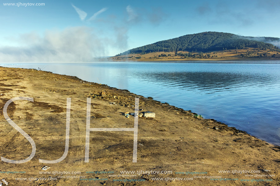 Landscape with Low clouds over water of Batak Reservoir, Pazardzhik Region, Bulgaria