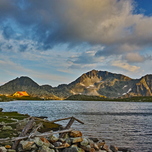 Yellow Sunset over Tevno Lake and Kamenitsa peak, Pirin mountain, Bulgaria