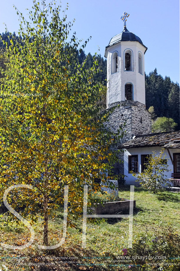 Church of the Assumption, river and Autumn tree in town of Shiroka Laka, Smolyan Region, Bulgaria