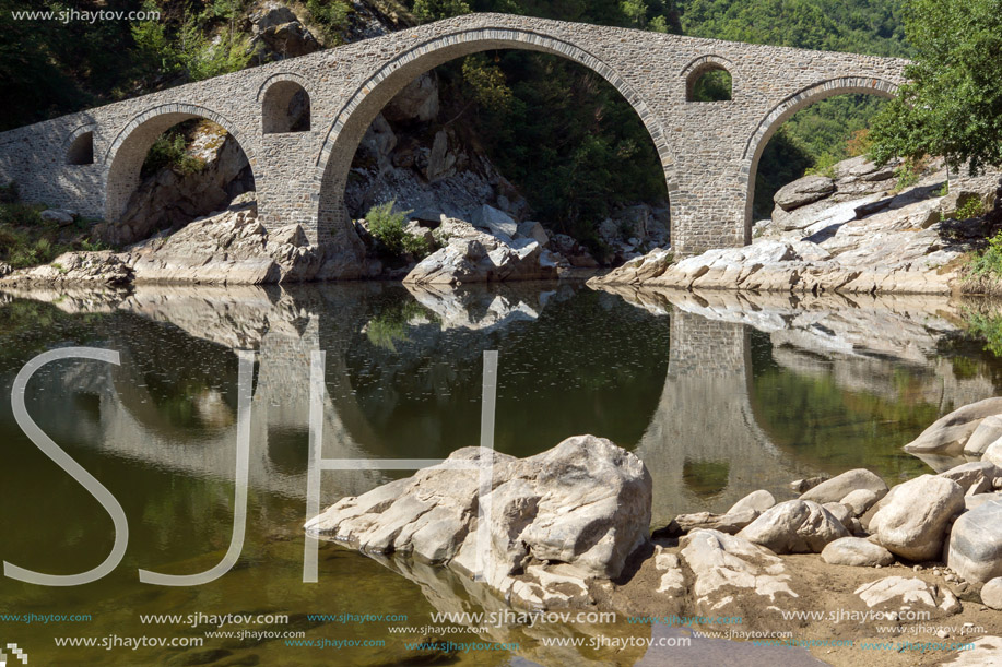 Reflection of Devil"s Bridge in Arda river and Rhodopes mountain, Kardzhali Region, Bulgaria