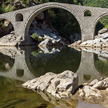 Reflection of Devil"s Bridge in Arda river and Rhodopes mountain, Kardzhali Region, Bulgaria