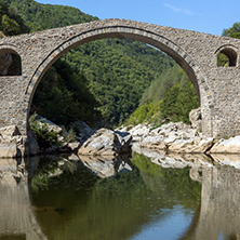 Reflection of Devil"s Bridge and Rhodopes mountain in Arda river, Kardzhali Region, Bulgaria