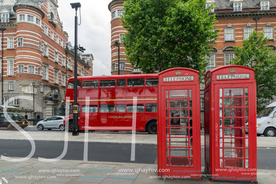 LONDON, ENGLAND - JUNE 16 2016: Phone booth and Red Bus on Westminster, London, England, Great Britain