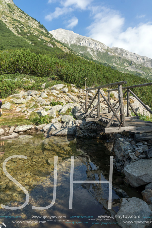 wooden bridge over river and Vihren Peak, Pirin Mountain, Bulgaria