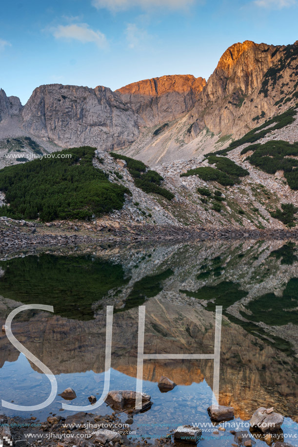 Sunrise with Colored in red rock of Sinanitsa peak and  the lake, Pirin Mountain, Bulgaria