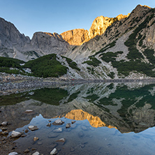 Sunrise with Colored in red rock of Sinanitsa peak and  the lake, Pirin Mountain, Bulgaria