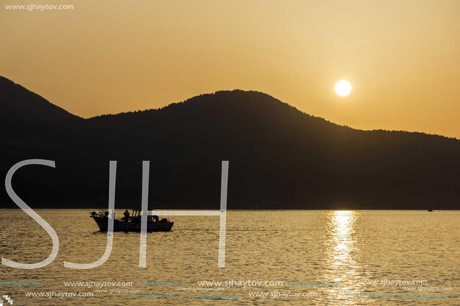 Amazing Sunset panorama with old boat in the sea of Thassos town, East Macedonia and Thrace, Greece