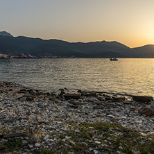 Amazing Sunset view with old boat in the sea of Thassos town, East Macedonia and Thrace, Greece