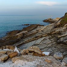 Amazing Sunset view with rocks in the sea of Thassos town, East Macedonia and Thrace, Greece