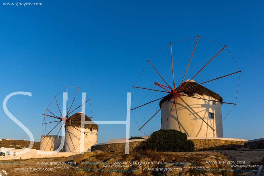 Sunset over White windmills on the island of Mykonos, Cyclades, Greece