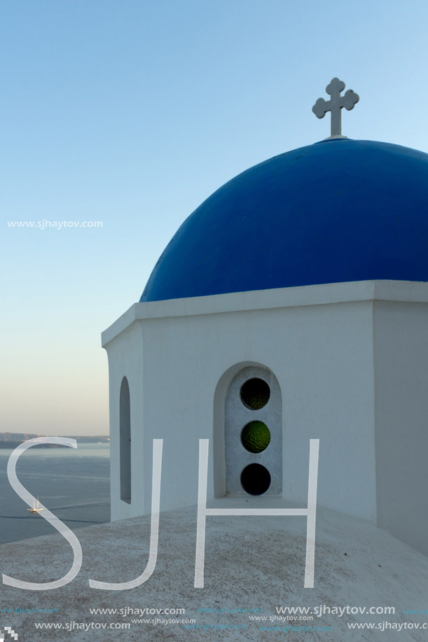 Church with blue roof in town of Oia and panorama to Santorini island, Thira, Cyclades, Greece