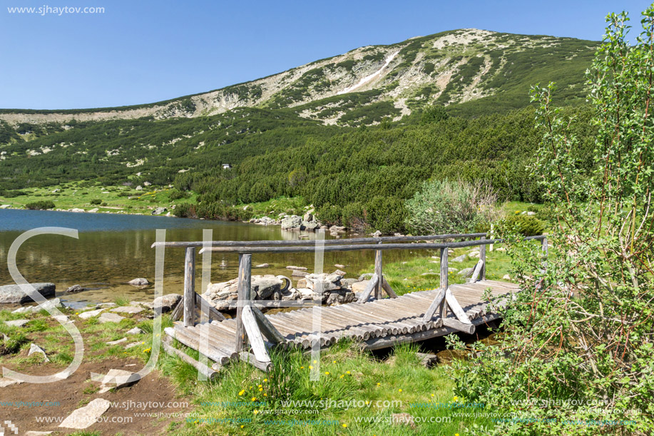 Landscape with wooden bridge over river in Pirin Mountain, Bezbog lake and peak, Bulgaria