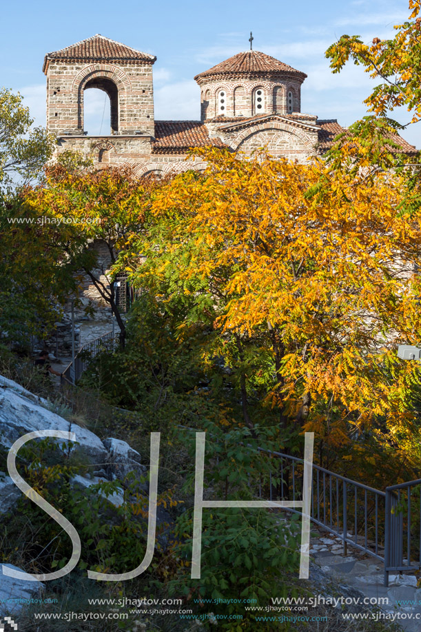 Yellow trees and Church of the Holy Mother of God in Asen"s Fortress, Asenovgrad, Plovdiv Region, Bulgaria