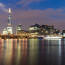 LONDON, ENGLAND - JUNE 17 2016: Night Panorama of Southwark Bridge, The Shard  skyscraper and Thames River, London, United Kingdom