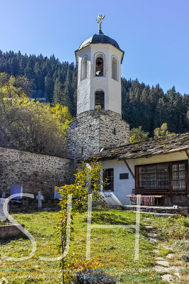 19th century Church of the Assumption, river and Autumn tree in town of Shiroka Laka, Smolyan Region, Bulgaria