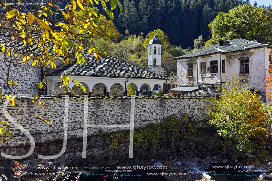 19th century Church of the Assumption, river and Autumn tree in town of Shiroka Laka, Smolyan Region, Bulgaria